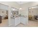 White kitchen cabinets, granite countertops and breakfast bar at 10662 Se 174Th Loop, Summerfield, FL 34491