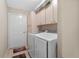 Laundry room with washer, dryer, and storage cabinets at 10662 Se 174Th Loop, Summerfield, FL 34491