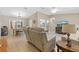 Spacious living room with beige leather furniture and a large TV at 10662 Se 174Th Loop, Summerfield, FL 34491