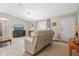Bright living room featuring a comfortable seating area and a large TV at 10662 Se 174Th Loop, Summerfield, FL 34491