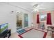 Bright sunroom with sliding door access to backyard and seating area at 10662 Se 174Th Loop, Summerfield, FL 34491