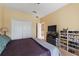 Bedroom with large bed, shoe storage and TV at 1070 Bentry Ct, Clermont, FL 34711