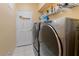 Laundry room with washer, dryer, and storage shelves at 1070 Bentry Ct, Clermont, FL 34711