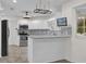 Updated kitchen featuring white cabinets, gray tile backsplash, and an island at 11631 Sw 82Nd Ter, Ocala, FL 34481