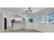 Eat-in kitchen with white cabinets, bay window, and upgraded light fixtures at 11631 Sw 82Nd Ter, Ocala, FL 34481