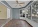 Sunroom with tiled floor, ceiling fan, and access to the backyard at 11631 Sw 82Nd Ter, Ocala, FL 34481