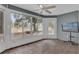 Sunroom with tile flooring and large windows showcasing backyard at 11631 Sw 82Nd Ter, Ocala, FL 34481