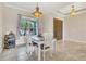 Charming dining area with white table and stylish light fixture at 12118 Still Meadow Dr, Clermont, FL 34711