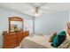 Bedroom with dresser, ceiling fan and bedding at 1330 Lajolla Cir, The Villages, FL 32159