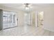 Main bedroom with tile floors, access to a patio, and a bathroom at 1330 Lajolla Cir, The Villages, FL 32159