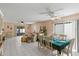 Open living and dining area with tile floors and a table set for 6 at 1330 Lajolla Cir, The Villages, FL 32159