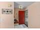 Inviting entryway with red door, tile flooring, and a small table at 1330 Lajolla Cir, The Villages, FL 32159