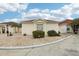 A sunny, one story home showcasing stone landscaping with a neatly trimmed exterior and neutral paint at 1330 Lajolla Cir, The Villages, FL 32159