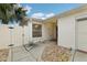 Front entrance with walkway, gate, and gravel landscaping at 1330 Lajolla Cir, The Villages, FL 32159