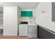 The laundry room offers washer, dryer, and ample space for storage and sorting at 1330 Lajolla Cir, The Villages, FL 32159