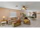 Living room with tile floors, sofa, and access to kitchen at 1330 Lajolla Cir, The Villages, FL 32159