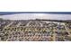 Aerial view of a lakefront community featuring many homes at 1387 Zest Ave, The Villages, FL 32163