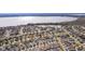 Aerial view of a community with lake access and numerous houses at 1387 Zest Ave, The Villages, FL 32163