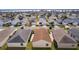 Aerial view showcasing a house's backyard and surrounding neighborhood at 1387 Zest Ave, The Villages, FL 32163