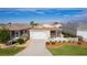 Single-story house with two-car garage and fenced yard at 1387 Zest Ave, The Villages, FL 32163