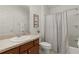 Clean bathroom with tub, shower, and wood vanity at 1387 Zest Ave, The Villages, FL 32163