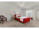 Cozy bedroom featuring a red bed frame and wicker chair at 1387 Zest Ave, The Villages, FL 32163