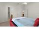 Red platform bed in bedroom with access to ensuite bathroom at 1387 Zest Ave, The Villages, FL 32163