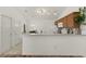 Modern kitchen with wood cabinets, breakfast bar, and stainless steel appliances at 1387 Zest Ave, The Villages, FL 32163