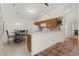 Eat-in kitchen with light wood cabinets, breakfast bar, and a tile floor at 1387 Zest Ave, The Villages, FL 32163