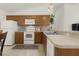 Updated kitchen with wood cabinets, stainless steel appliances, and tile flooring at 1387 Zest Ave, The Villages, FL 32163