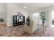 Living room with beige couch, glass table, and open concept floorplan at 1387 Zest Ave, The Villages, FL 32163