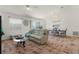 Living room with light beige couch and view into dining area at 1387 Zest Ave, The Villages, FL 32163