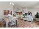 Open living and dining area with light flooring and neutral decor at 1387 Zest Ave, The Villages, FL 32163