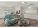 Bright living room with vaulted ceiling, comfy couch, and glass-top coffee table at 1387 Zest Ave, The Villages, FL 32163