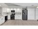 Modern kitchen with white cabinets, stainless steel appliances, and quartz countertops at 1463 Cedar Glen Dr, Apopka, FL 32712