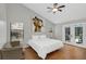 Main bedroom with large window, hardwood floors, and access to a patio at 1463 Cedar Glen Dr, Apopka, FL 32712