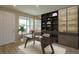 Bright home office features built-in shelving and a large work desk at 16404 Hamlin Hills Rd, Winter Garden, FL 34787