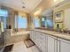 Spa-like bathroom with double sinks and a walk-in shower at 172 Crepe Myrtle Dr, Groveland, FL 34736