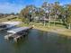 Aerial view showcasing waterfront property and boathouse at 17531 County Road 455, Montverde, FL 34756