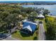 Aerial view of blue home with trees and blue lake in the background on a clear day at 17531 County Road 455, Montverde, FL 34756