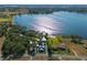 Aerial view of community and lake showcasing houses, docks, trees and waterfront on a sunny day at 17531 County Road 455, Montverde, FL 34756