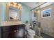 Updated bathroom features framed mirror, vanity with marble countertop, toilet and shower with glass door at 17531 County Road 455, Montverde, FL 34756