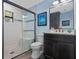 Clean bathroom with a walk-in shower and dark vanity at 17531 County Road 455, Montverde, FL 34756