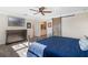 Spacious bedroom with large bed, dresser, and barn door at 17531 County Road 455, Montverde, FL 34756