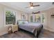 Cozy bedroom with a queen-size bed and bay window at 17531 County Road 455, Montverde, FL 34756