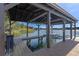 Covered boat dock featuring a picnic table and lift at 17531 County Road 455, Montverde, FL 34756
