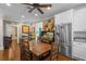 Dining space with dark wood table, chairs, and stainless steel refrigerator at 17531 County Road 455, Montverde, FL 34756