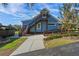 Charming blue house with wooden stairs and walkway at 17531 County Road 455, Montverde, FL 34756