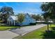Light blue home with metal roof, driveway, and landscaping at 17531 County Road 455, Montverde, FL 34756