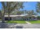 House exterior showcasing a ranch style home with a metal roof and large windows at 17531 County Road 455, Montverde, FL 34756